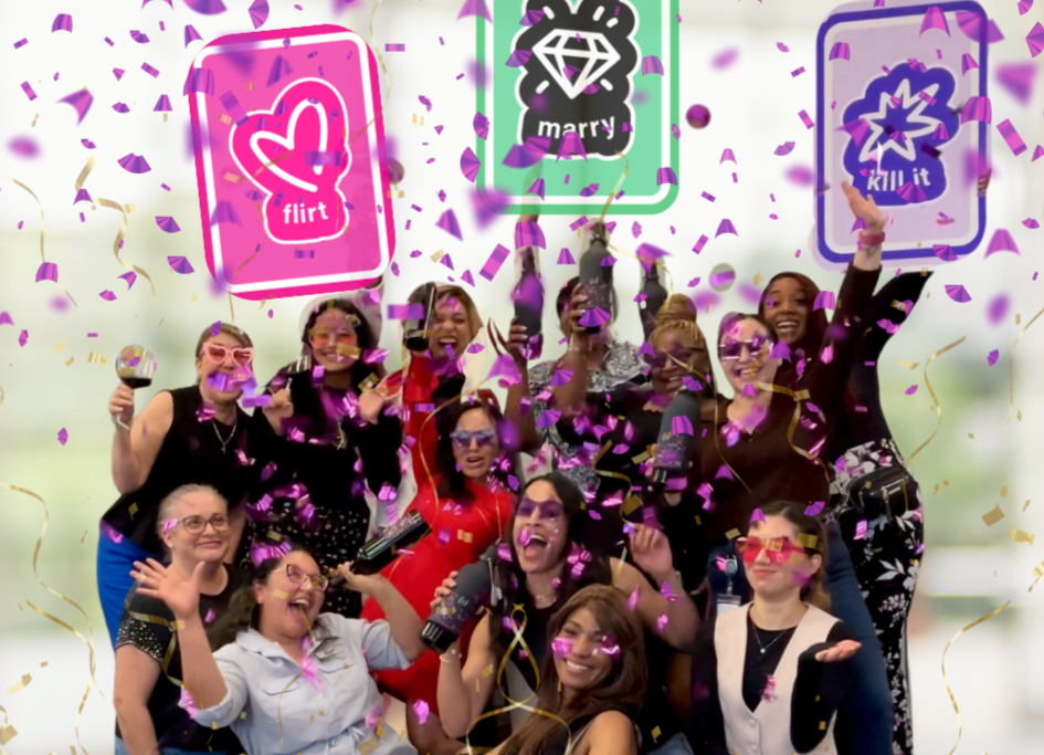 group of women holding flirt marry kill it FMK cards with confetti