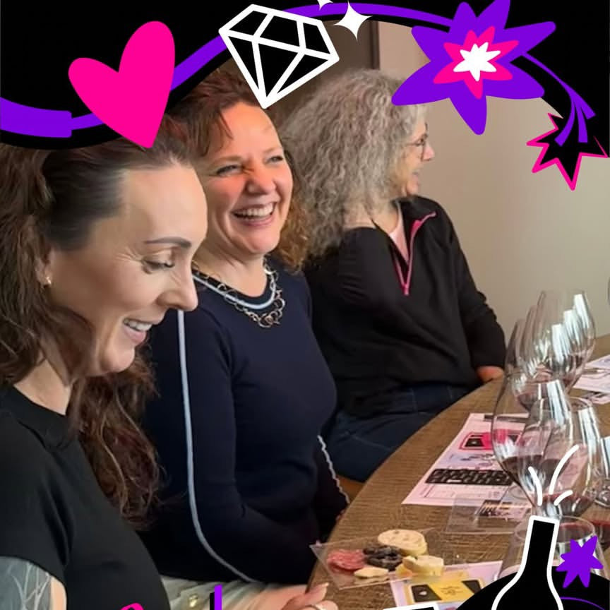 Three women sitting at a table playing FMK wine game